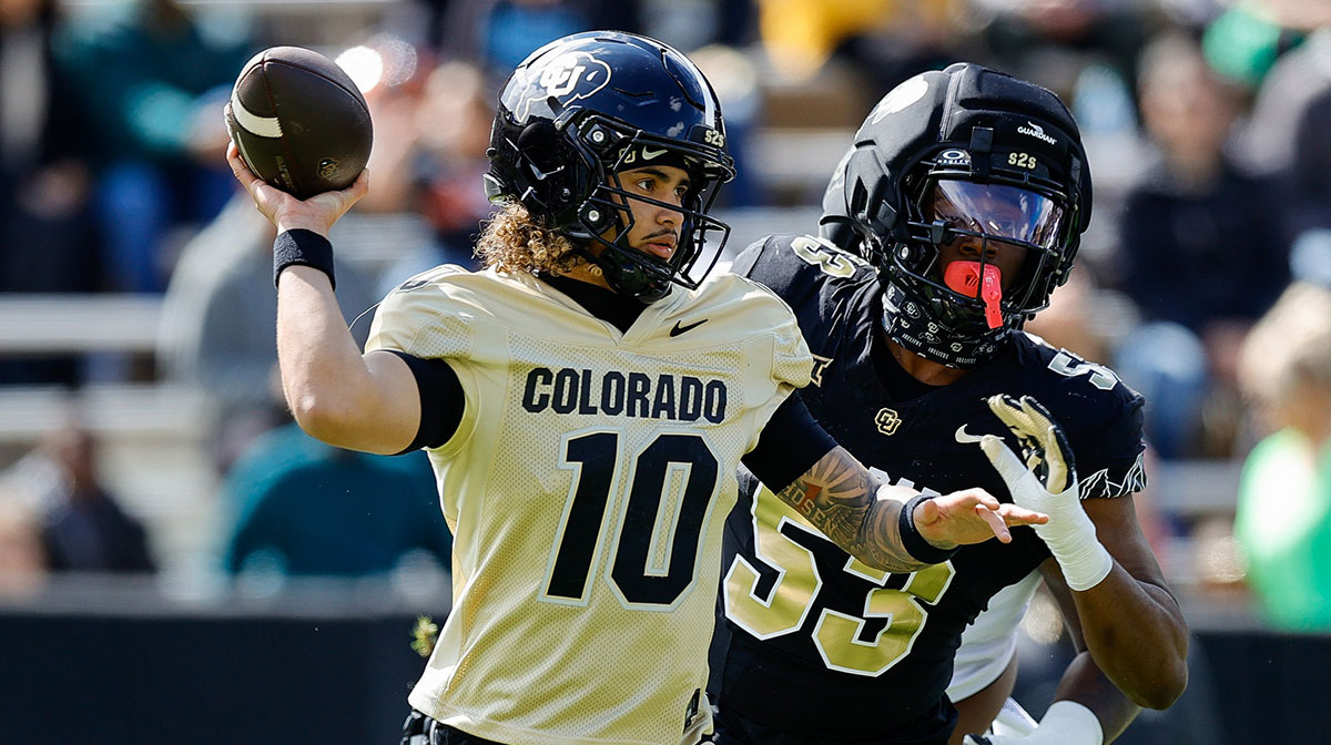 Colorado Buffaloes quarterback Julian Lewis (10) and defensive end Arden Walker (53) during the spring game at Folsom Field.