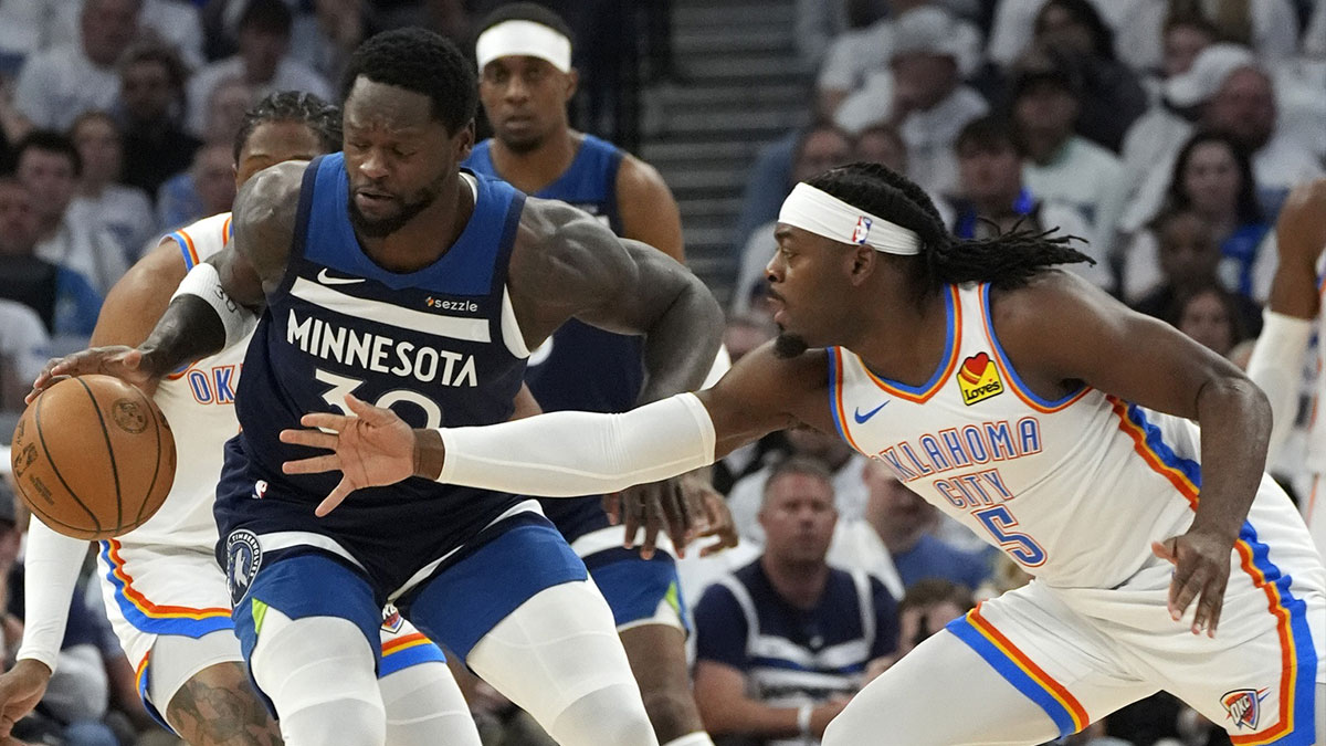 Minnesota Timberwolves forward Julius Randle (30) dribbles the ball against Oklahoma City Thunder guard Luguentz Dort (5) in the first half in game four of the western conference finals for the 2025 NBA Playoffs at Target Center.
