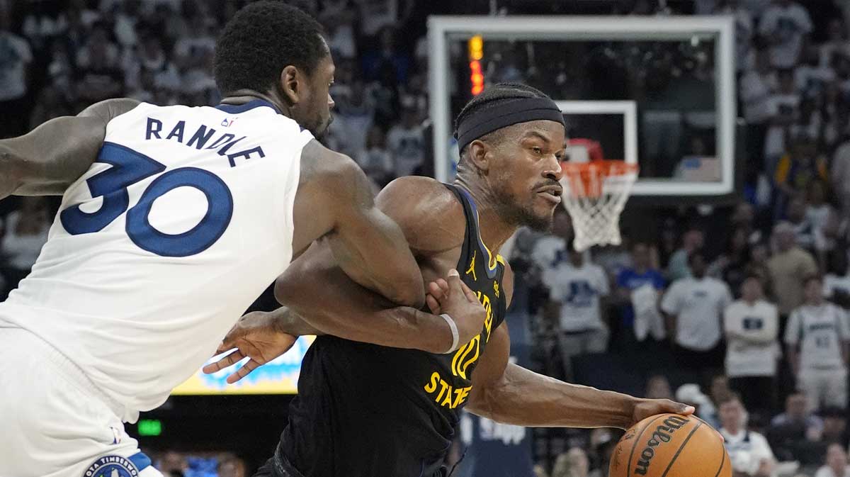 Minnesota Timberwolves forward Julius Randle (30) fouls Golden State Warriors forward Jimmy Butler (10) in the fourth quarter during game one of the second round for the 2025 NBA Playoffs at Target Center.