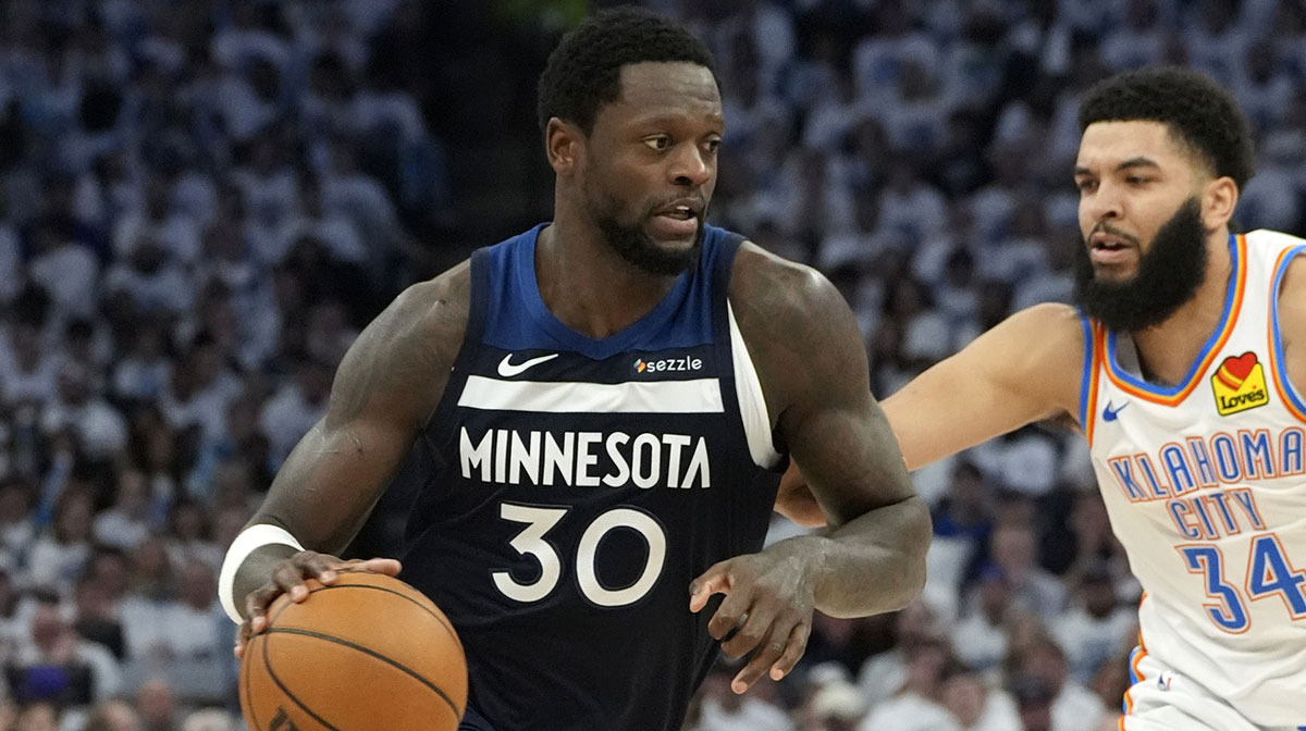 Minnesota Timberwolves forward Julius Randle (30) dribbles the ball against Oklahoma City Thunder forward Kenrich Williams (34) during the second half in game three of the western conference finals for the 2025 NBA Playoffs at Target Center.