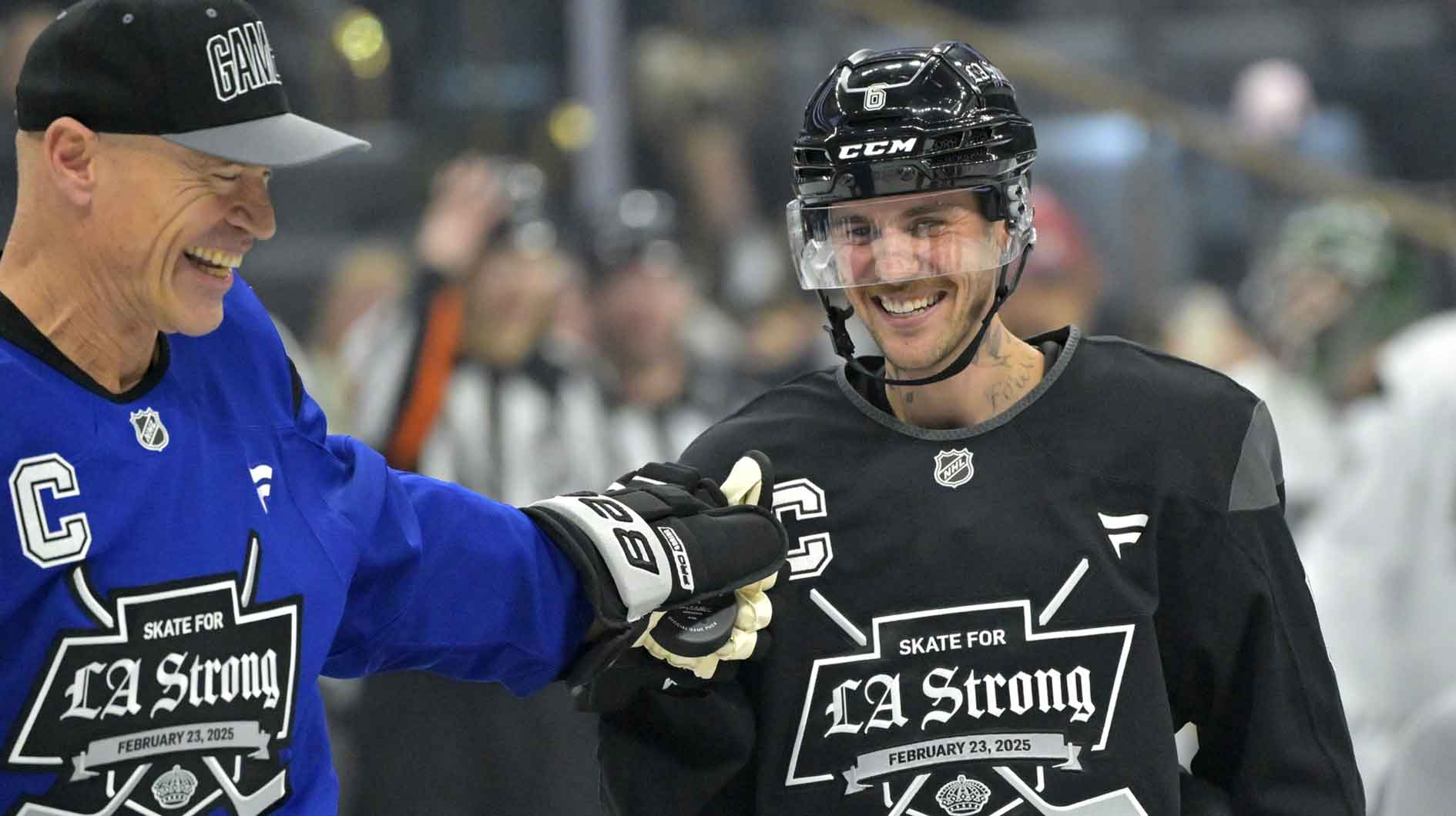Feb 23, 2025; Los Angeles, CA, USA; Former NHL player Mark Messier give a fist pump to Justin Bieber following the ceremonial puck drop at the Los Angeles Kings Celebrity Charity Game for LA Wildfire Relief at Crypto.com Arena. teams. Mandatory Credit: Jayne Kamin-Oncea-Imagn Images