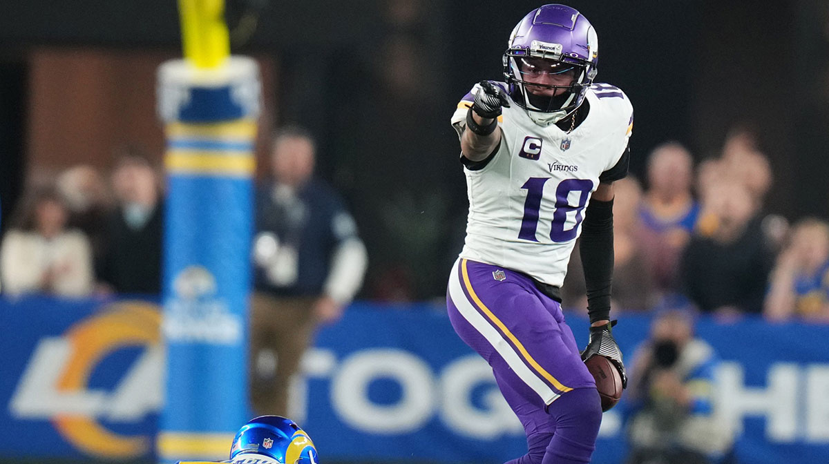 Minnesota Vikings receiver Justin Jefferson (18) signals a first down after a catch against the Los Angeles Rams during their playoff game at State Farm Stadium.