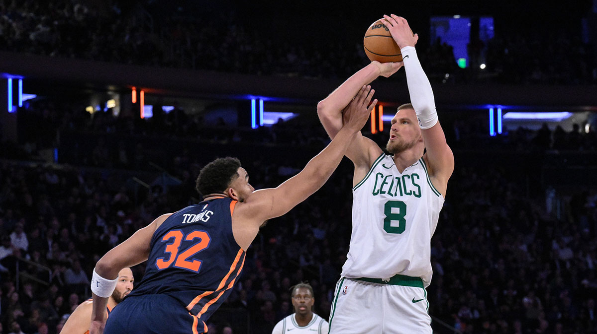 Boston Celtics center Kristaps Porzingis (8) shoots the ball while being defended by New York Knicks center Karl-Anthony Towns (32) during the second half at Madison Square Garden.