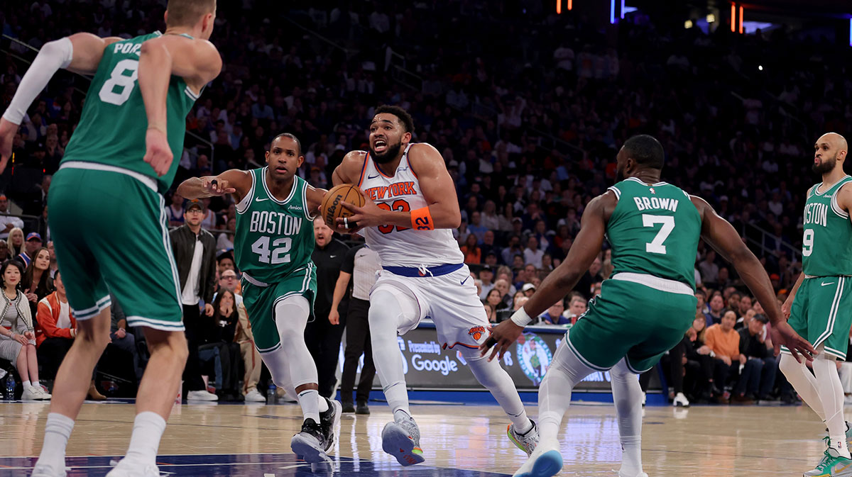 New York Knicks center Karl-Anthony Towns (32) drives to the basket against Boston Celtics centers Kristaps Porzingis (8) and Al Horford (42) and guards Jaylen Brown (7) and Derrick White (9) during the first quarter of game six in the second round of the 2025 NBA Playoffs at Madison Square Garden.