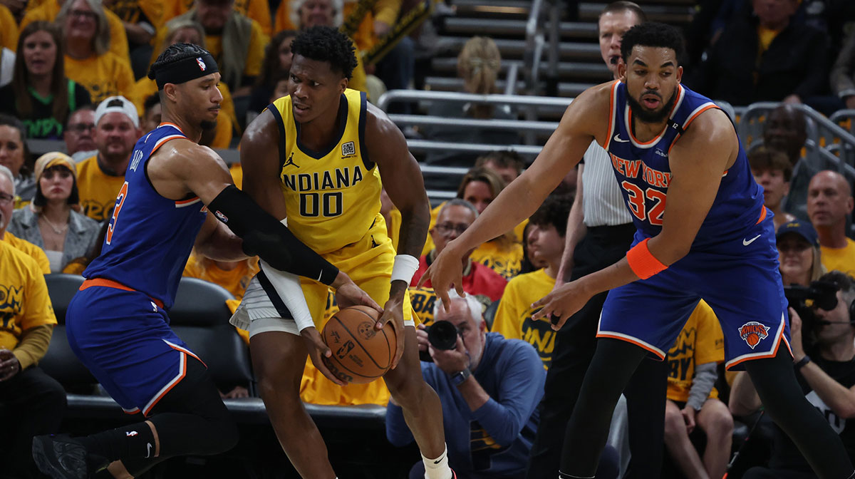 Indiana Pacers guard Bennedict Mathurin (00) drives to the hoop past New York Knicks guard Josh Hart (3) and center Karl-Anthony Towns (32) during the second quarter of game three of the eastern conference finals for the 2025 NBA Playoffs at Gainbridge Fieldhouse.