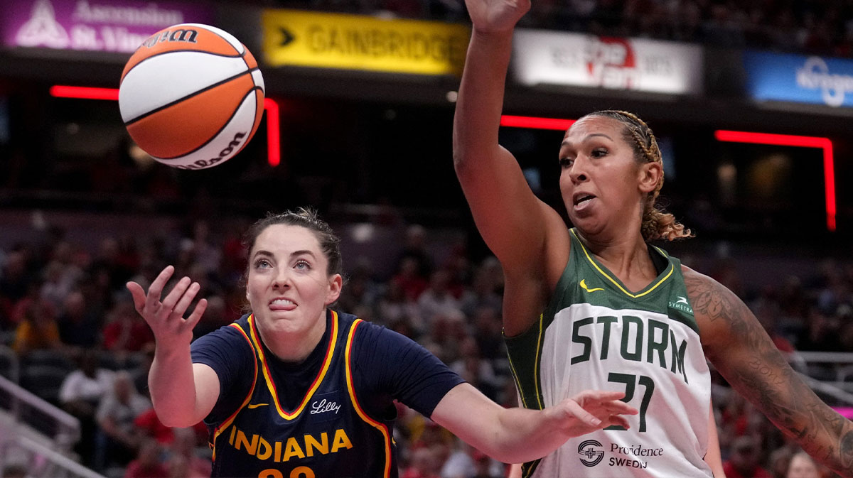 Indiana Fever forward Katie Lou Samuelson (33) and Seattle Storm center Mercedes Russell (21) reach for a ball during the first half of a game Sunday, Aug. 18, 2024, at Gainbridge Fieldhouse in Indianapolis.