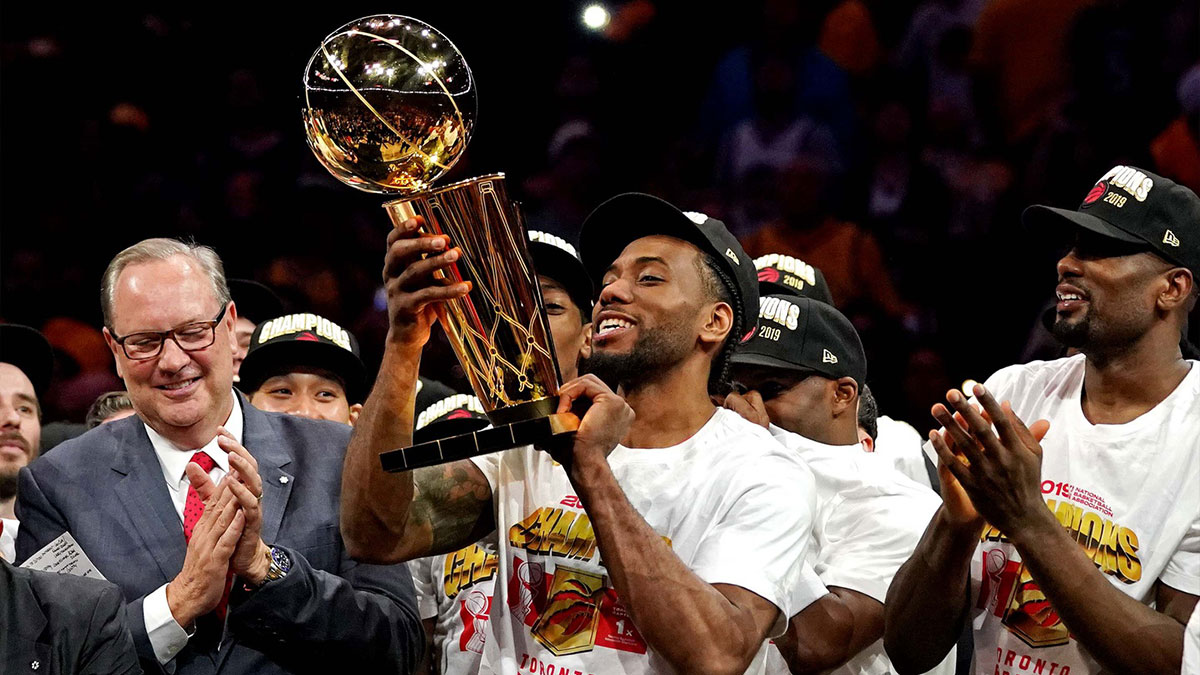 Toronto Raptors forward Kawhi Leonard (2) celebrates with the Larry O'Brien Trophy after the Golden State Warriors in game six of the 2019 NBA Finals at Oracle Arena.