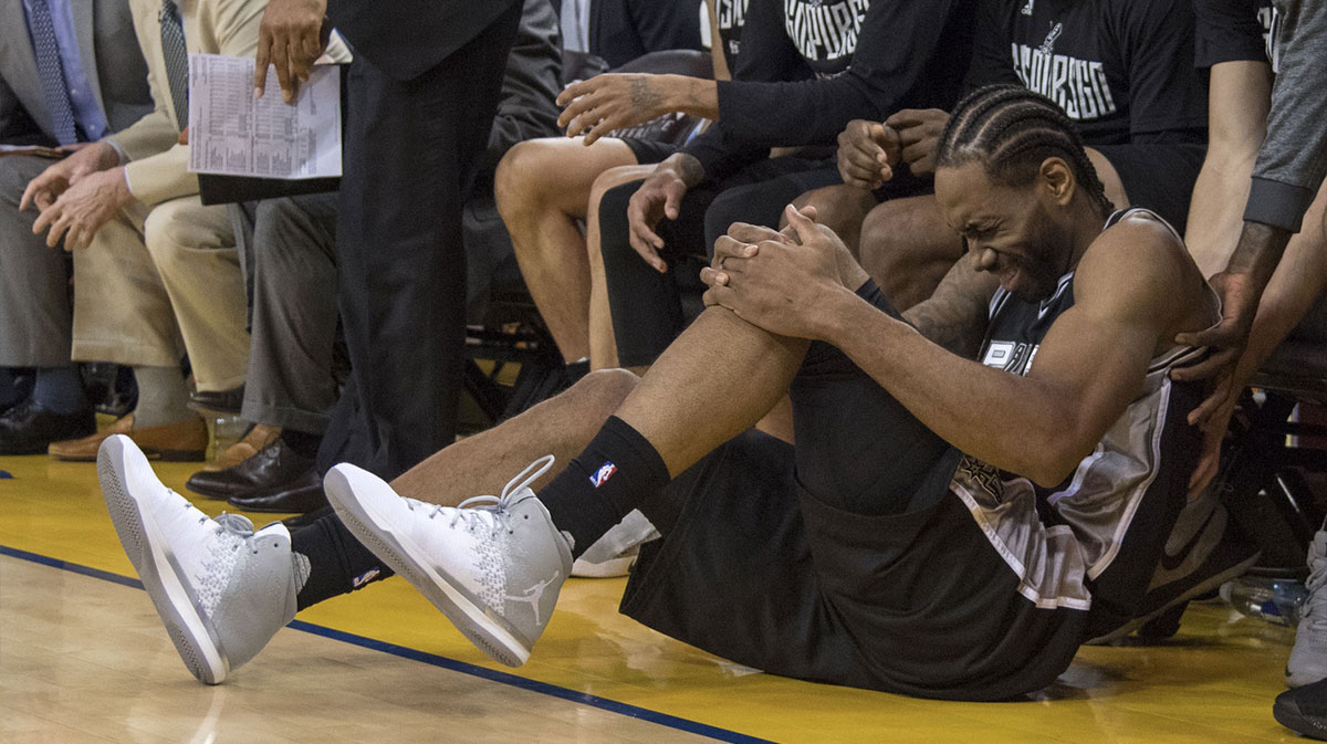 San Antonio Spurs forward Kawhi Leonard (2) reacts after an injury during the third quarter in game one of the Western conference finals of the 2017 NBA Playoffs against the Golden State Warriors at Oracle Arena. The Warriors defeated the Spurs 113-111.