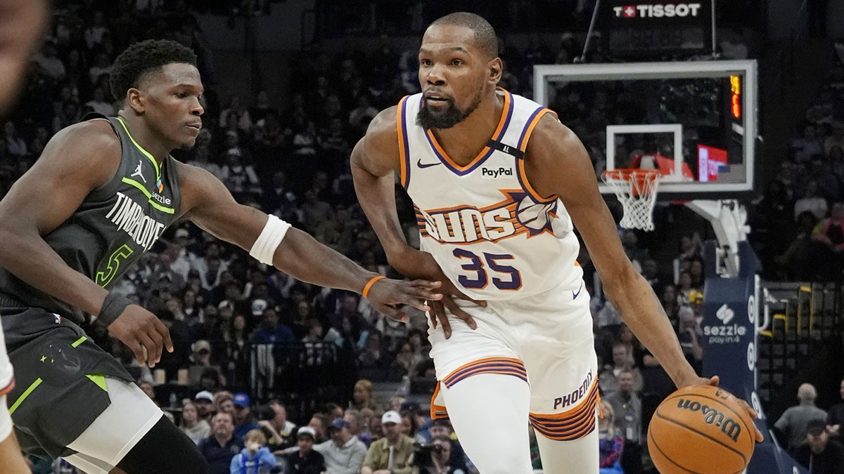 Phoenix Suns forward Kevin Durant (35) brings the ball up as Minnesota Timberwolves guard Anthony Edwards (5) defends him in the fourth quarter at Target Center. Bruce Kluckhohn-Imagn Images