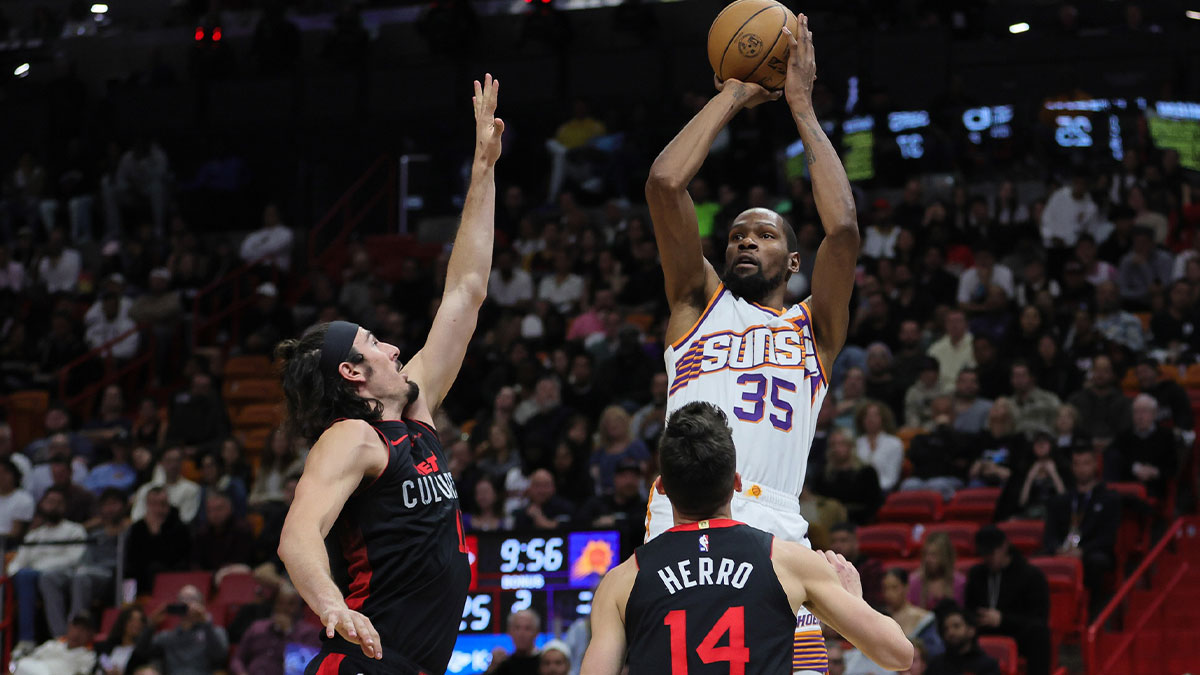 Phoenix Suns forward Kevin Durant (35) shoots the basketball over Miami Heat guard Jaime Jaquez Jr. (11) and guard Tyler Herro (14) during the second quarter at Kaseya Center.