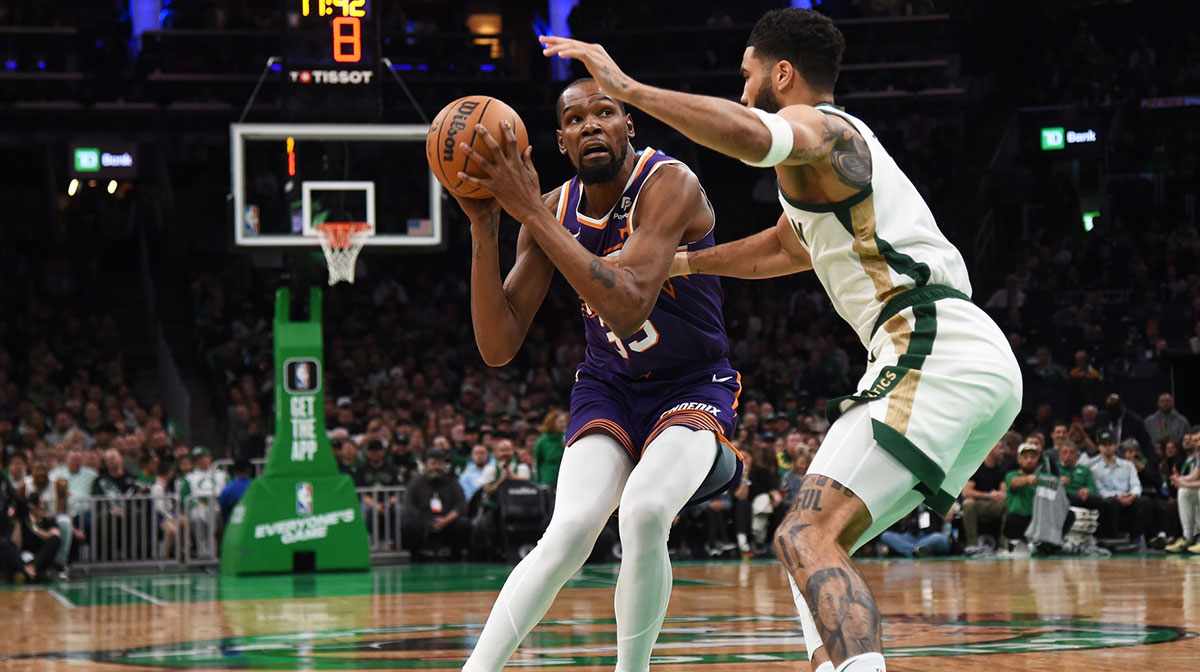 Phoenix Suns forward Kevin Durant (35) controls the ball while Boston Celtics forward Jayson Tatum (0) defends during the first half at TD Garden.