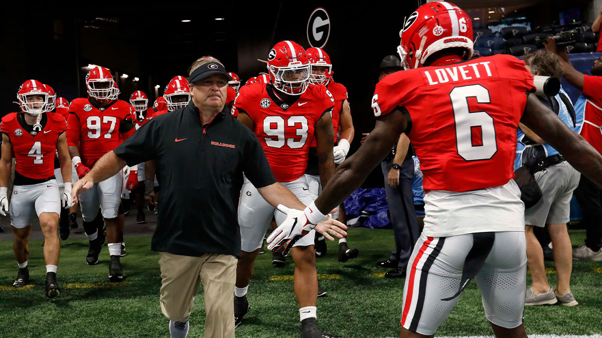 Georgia coach Kirby Smart leads his team onto the field for warm ups before the start of the NCAA Aflac Kickoff Game