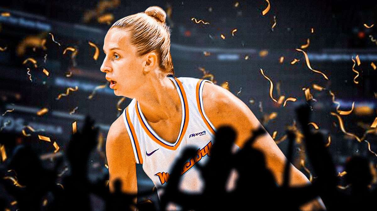Kitija Laksa in a Phoenix Mercury jersey with confetti around her, and silhouettes of fans below her, and a background of the Mercury home arena.