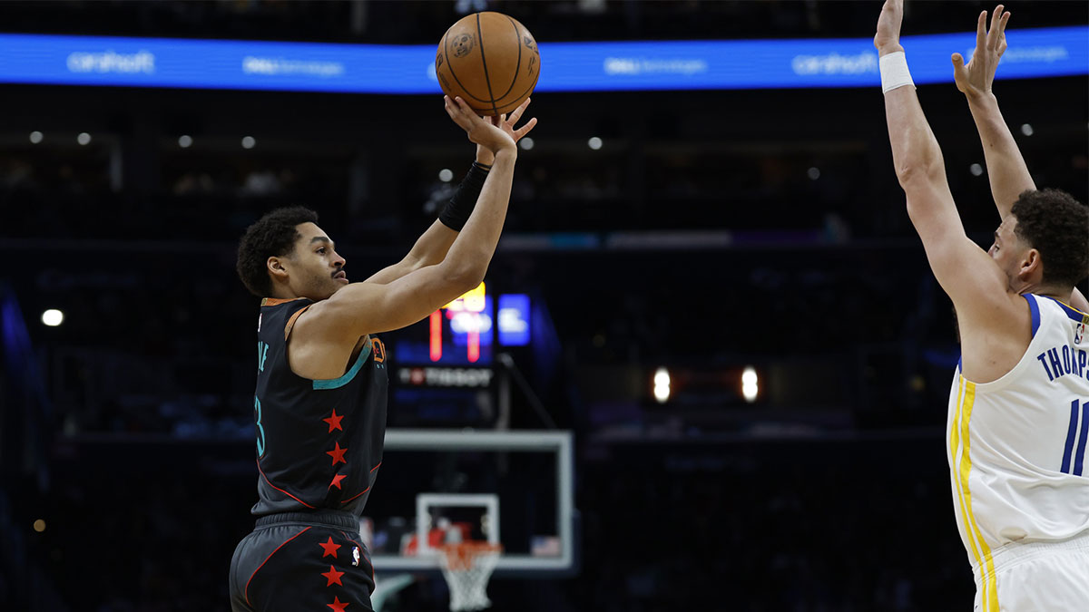 Washington Wizards guard Jordan Poole (13) shoots the ball over Golden State Warriors guard Klay Thompson (11) in the first half at Capital One Arena.