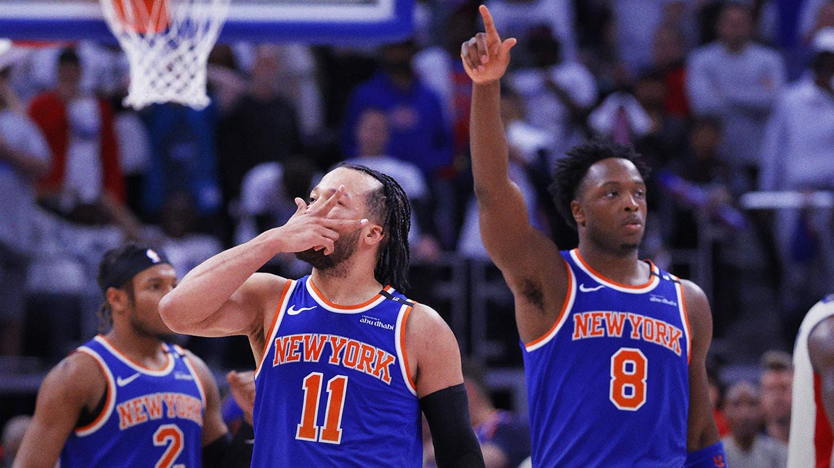 Knicks guard Jalen Brunson (11) celebrates his three point basket in the fourth quarter against the Detroit Pistons during game six of first round for the 2024 NBA Playoffs at Little Caesars Arena next to TNT's Shaquille O'Neal with the Celtics logo in the background