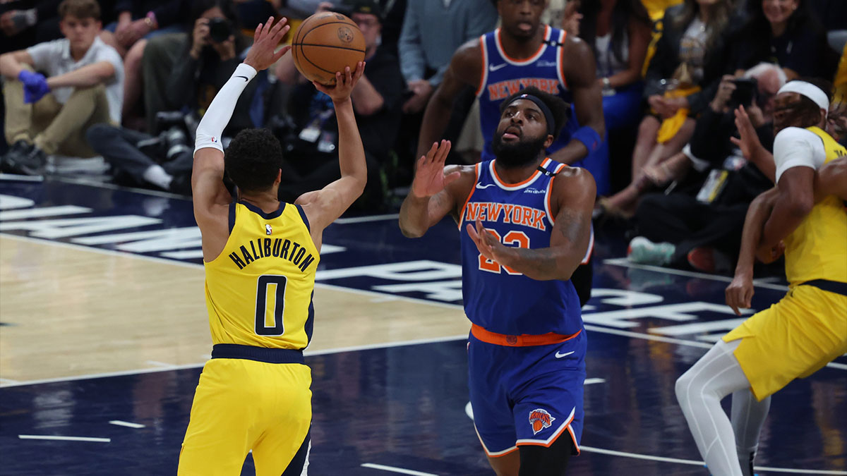 Indiana Pacers guard Tyrese Haliburton (0) shoots a three point basket over New York Knicks center Mitchell Robinson (23) during the first quarter of game four of the eastern conference finals for the 2025 NBA Playoffs at Gainbridge Fieldhouse.