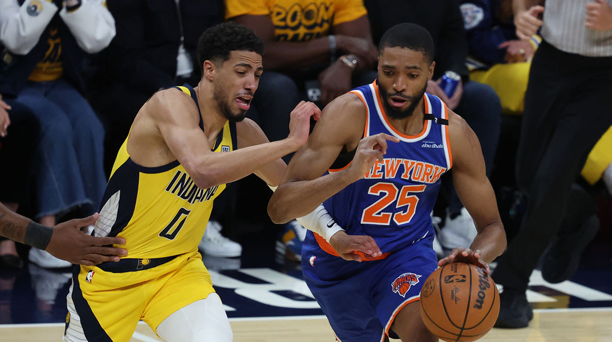 New York Knicks forward Mikal Bridges (25) drives to the hoop past Indiana Pacers guard Tyrese Haliburton (0) during the first quarter of game three of the Eastern Conference finals for the 2025 NBA Playoffs at Gainbridge Fieldhouse.