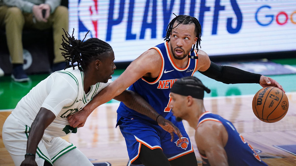 New York Knicks guard Jalen Brunson (11) moves the ball against Boston Celtics guard Jrue Holiday (4) in overtime during game one of the second round for the 2025 NBA Playoffs at TD Garden.