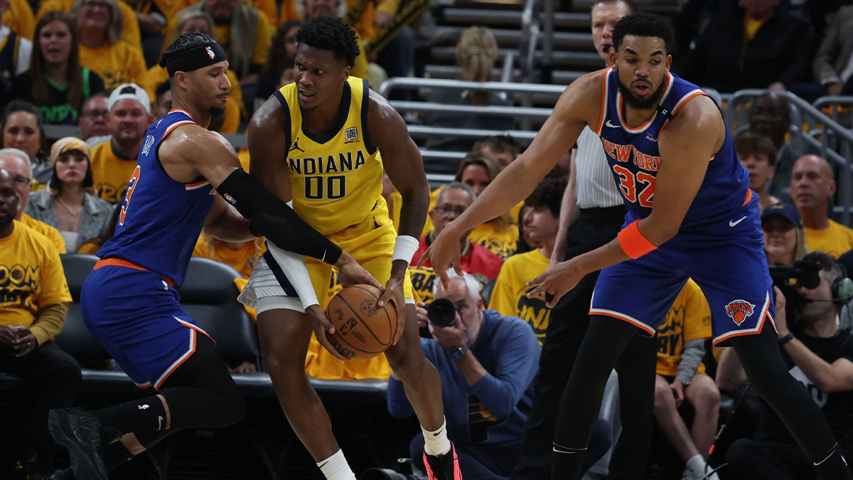 Indiana Pacers guard Bennedict Mathurin (00) drives to the hoop past New York Knicks guard Josh Hart (3) and center Karl-Anthony Towns (32) during the second quarter of game three of the eastern conference finals for the 2025 NBA Playoffs at Gainbridge Fieldhouse.
