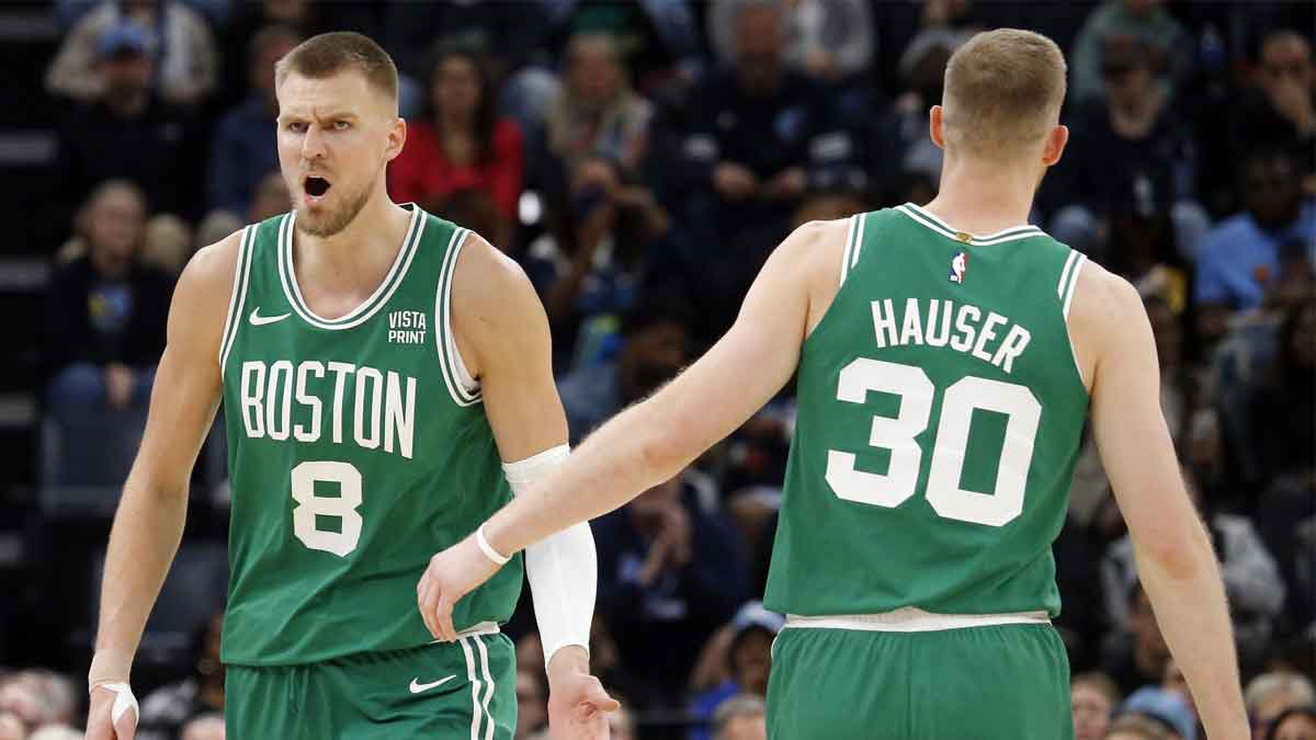 Boston Celtics center Kristaps Porzingis (8) reacts with Boston Celtics forward Sam Hauser (30) during the second half against the Memphis Grizzlies at FedExForum.