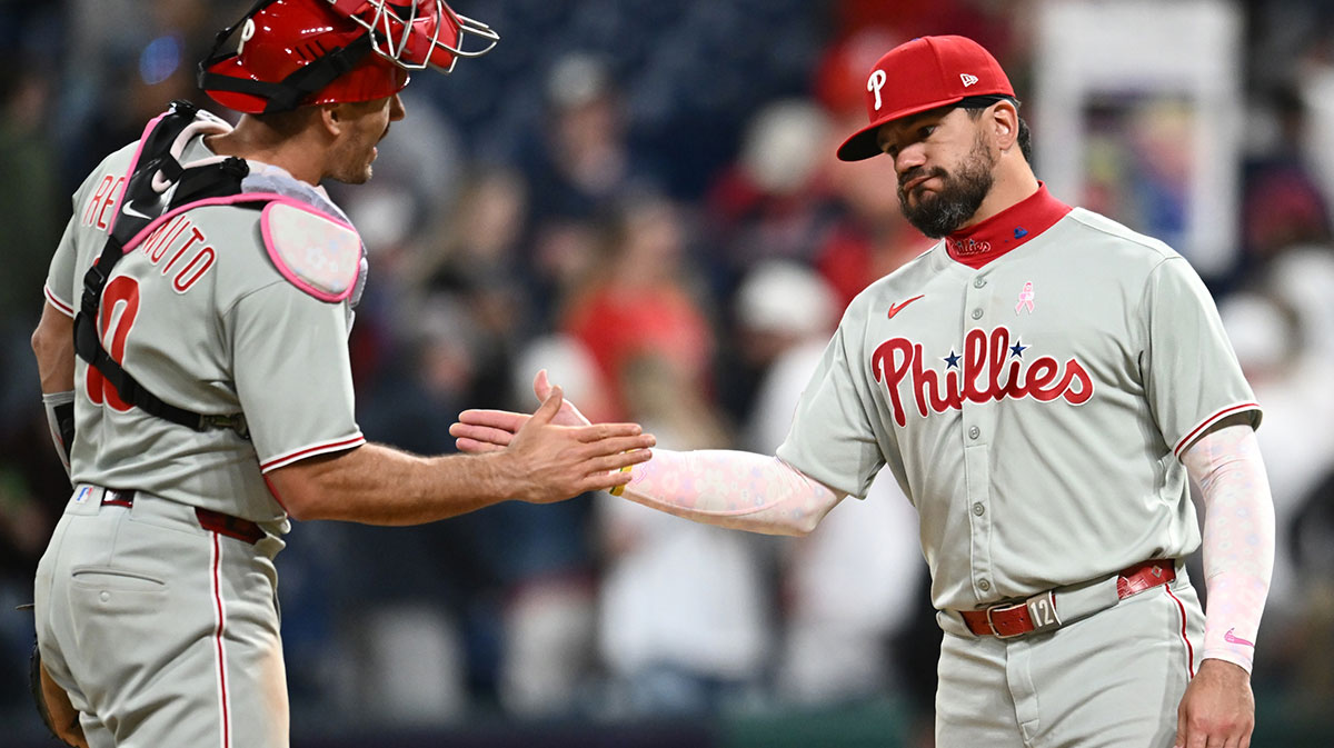 Philadelphia Phillies catcher J.T. Realmuto (10) and designated hitter Kyle Schwarber (12) celebrate after the Phillies beat the Cleveland Guardians at Progressive Field.