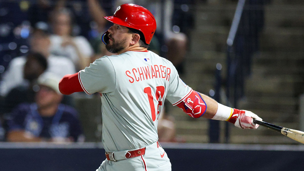 Philadelphia Phillies designated hitter Kyle Schwarber (12) hits an rbi single against the Tampa Bay Rays in the eighth inning at George M. Steinbrenner Field.