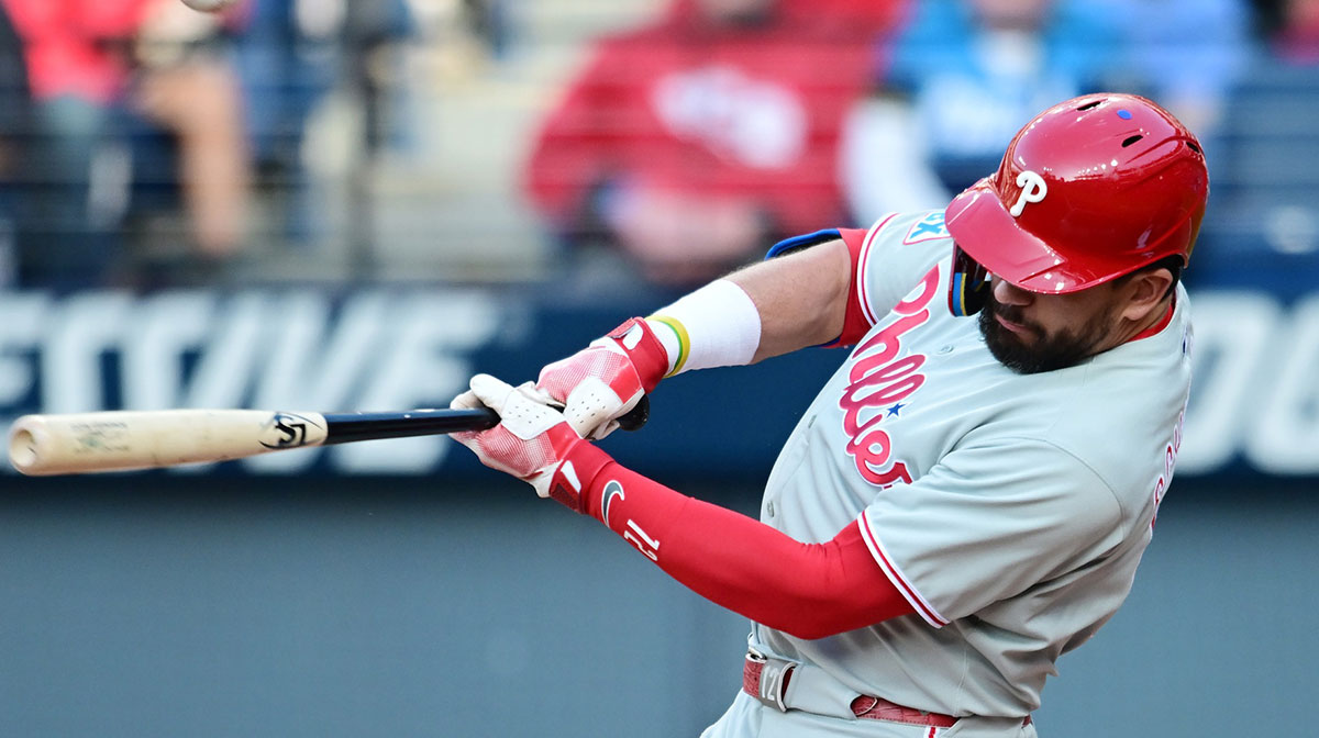 Philadelphia Phillies designated hitter Kyle Schwarber (12) hits an RBI single during the fourth inning against the Cleveland Guardians at Progressive Field.