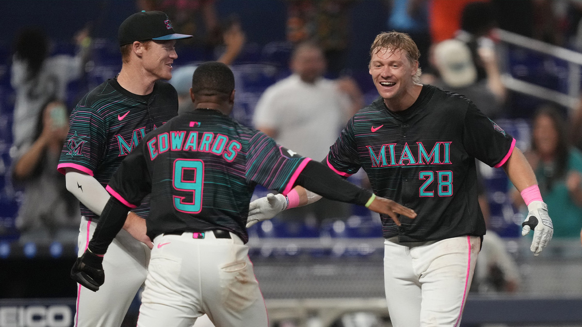 Miami Marlins right fielder Kyle Stowers (28) celebrates his walk-off grand slam in the ninth inning against the Oakland Athletics with shortstop Xavier Edwards (9) and first baseman Eric Wagaman (33) at loanDepot Park.