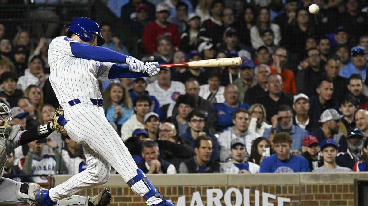 Chicago Cubs outfielder Kyle Tucker (30) hits an RBI triple against the Miami Marlins during the fifth inning at Wrigley Field.