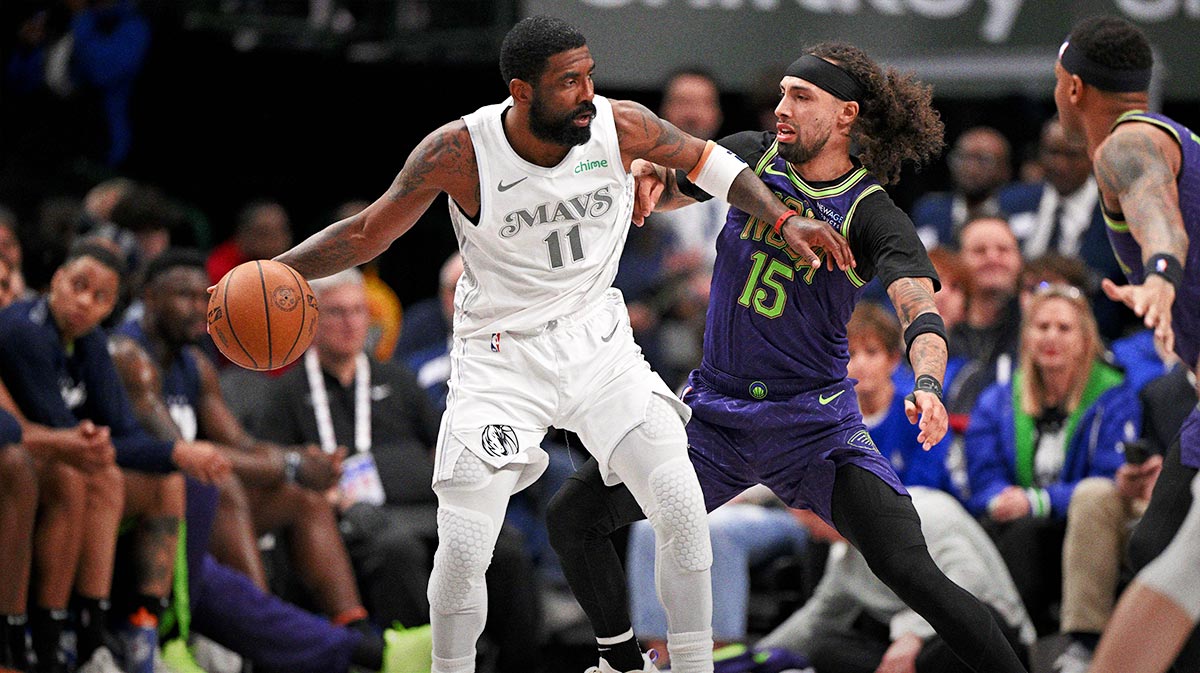 Dallas Mavericks guard Kyrie Irving (11) looks to move the ball past New Orleans Pelicans guard Jose Alvarado (15) during the second quarter at the American Airlines Center.