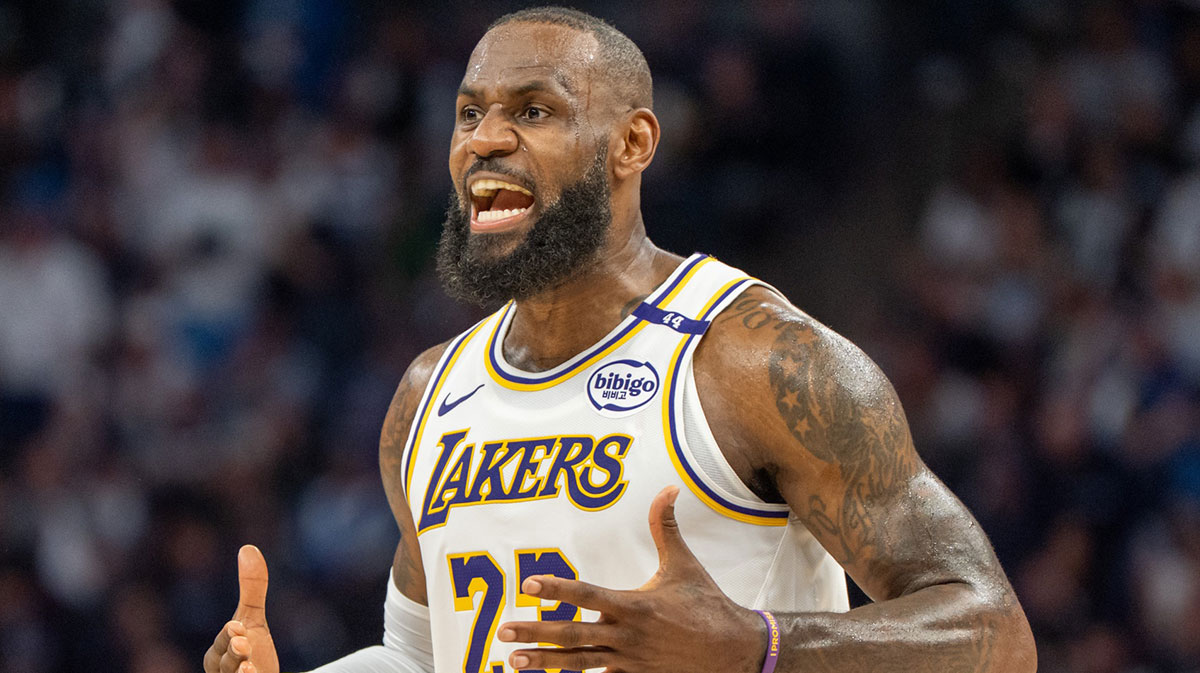 Los Angeles Lakers forward LeBron James (23) talks with his coach during a stoppage in play against the Minnesota Timberwolves in the second quarter during game four of first round for the 2025 NBA Playoffs at Target Center.