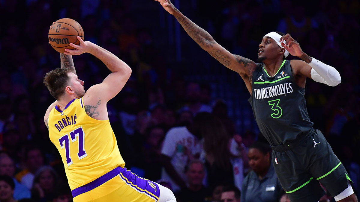 Los Angeles Lakers guard Luka Doncic (77) shoots against Minnesota Timberwolves forward Jaden McDaniels (3) during the second half in game five of first round for the 2025 NBA Playoffs at Crypto.com Arena.