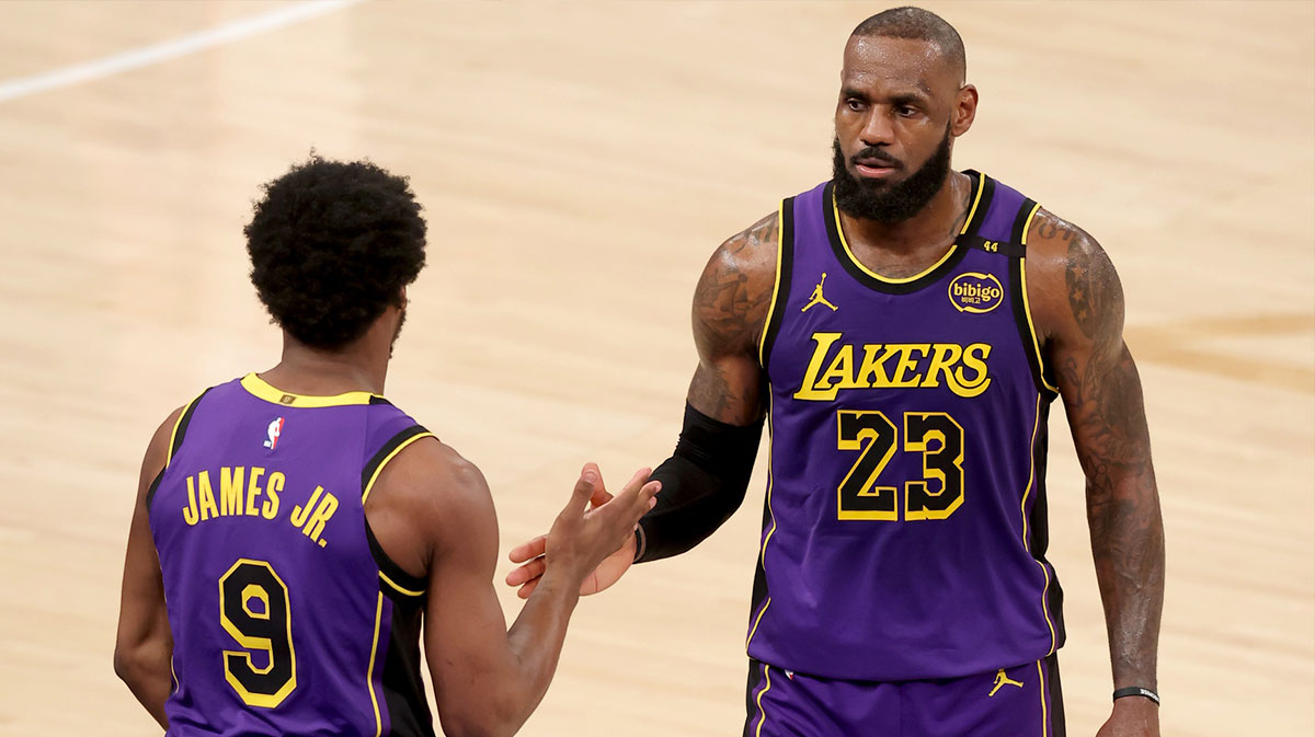 Los Angeles Lakers guard Bronny James (9) checks in for forward LeBron James (23) during the fourth quarter against the New York Knicks at Madison Square Garden.