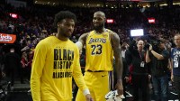 Los Angeles Lakers forward LeBron James (23) celebrates victory over the Portland Trail Blazers with his son guard Bronny James (9) at Moda Center.