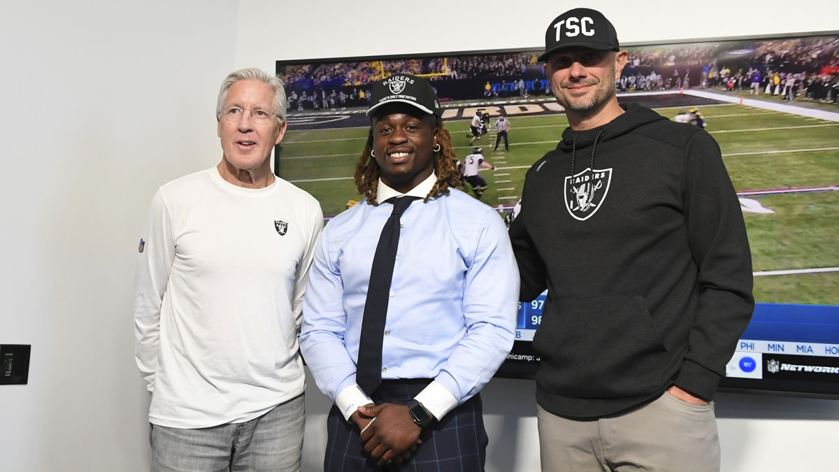 Las Vegas Raiders head coach Pete Carroll, Ashton Jeanty and general manager John Spytek pose after a news conference introducing Jeanty as the first round draft pick in the 2025 NFL Draft at Intermountain Health Performance Center.