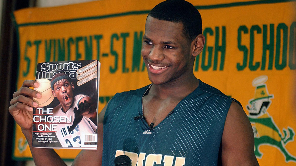 LeBron James holds an issue of Sports Illustrated on Feb. 13, 2002. James was on SI's cover as a junior at St. Vincent-St. Mary High School. Cover Boy Is All Smiles