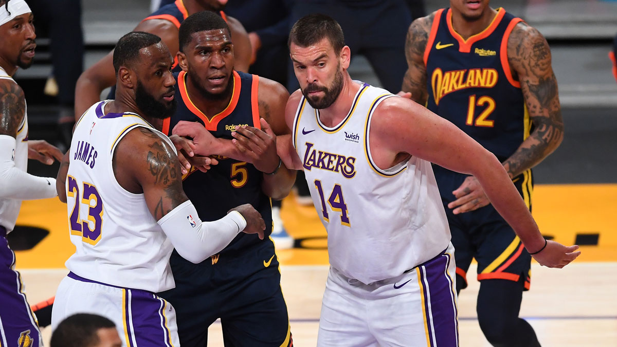 Los Angeles Lakers forward LeBron James (23) and center Marc Gasol (14) box out Golden State Warriors center Kevon Looney (5) under the basket in the first half of the game at Staples Center.