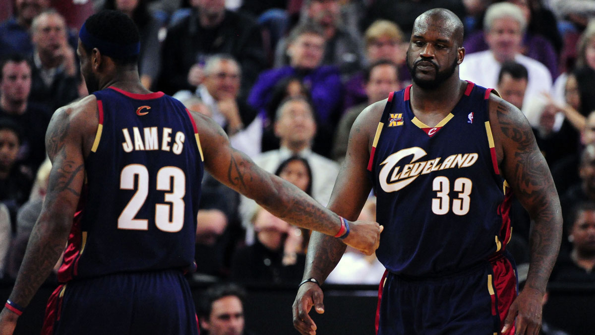 Cleveland Cavaliers center Shaquille O'Neal (33) receives a hand shake from forward LeBron James (23) after receiving his third foul during the second quarter against the Sacramento Kings at Arco Arena. The Cavaliers defeated the Kings 117-104.