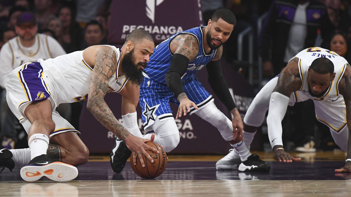 Los Angeles Lakers center Tyson Chandler (5) goes to the floor for loose ball as Orlando Magic guard D.J. Augustin (14) moves in during the fourth quarter at Staples Center. Right is Los Angeles Lakers forward LeBron James (23).
