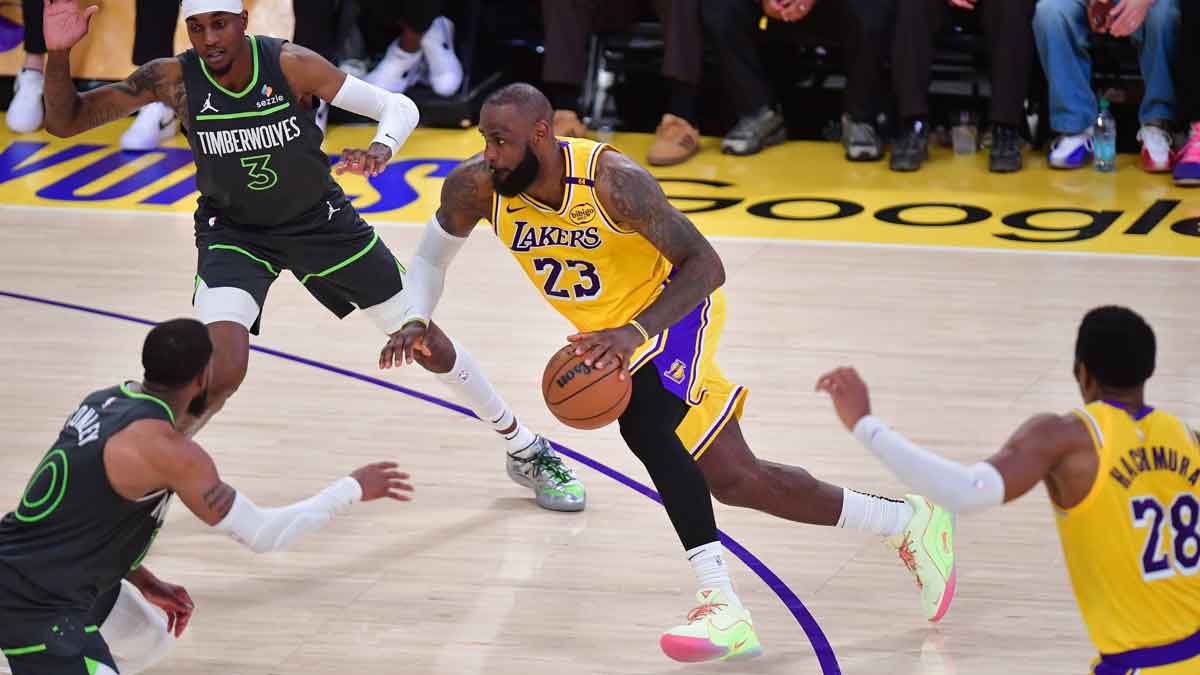 Los Angeles Lakers forward LeBron James (23) moves to the basket against Minnesota Timberwolves forward Jaden McDaniels (3) and guard Mike Conley (10) during the second half in game five of first round for the 2025 NBA Playoffs at Crypto.com Arena.