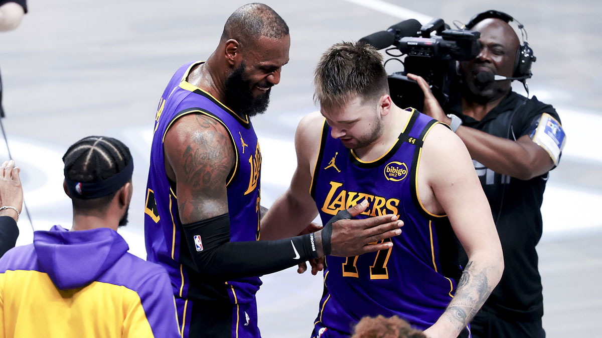 Los Angeles Lakers forward LeBron James (23) celebrates with Los Angeles Lakers guard Luka Doncic (77) during the fourth quarter against the Dallas Mavericks at American Airlines Center.
