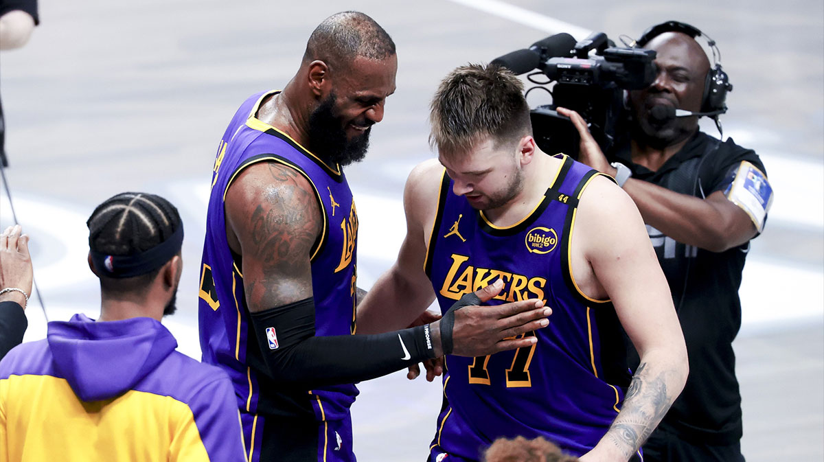 Los Angeles Lakers forward LeBron James (23) celebrates with Los Angeles Lakers guard Luka Doncic (77) during the fourth quarter.