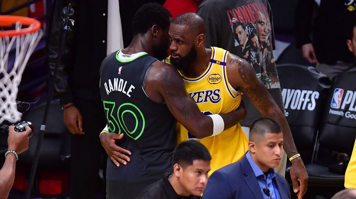 Minnesota Timberwolves forward Julius Randle (30) meets with Los Angeles Lakers forward LeBron James (23) following game five of first round for the 2025 NBA Playoffs at Crypto.com Arena.