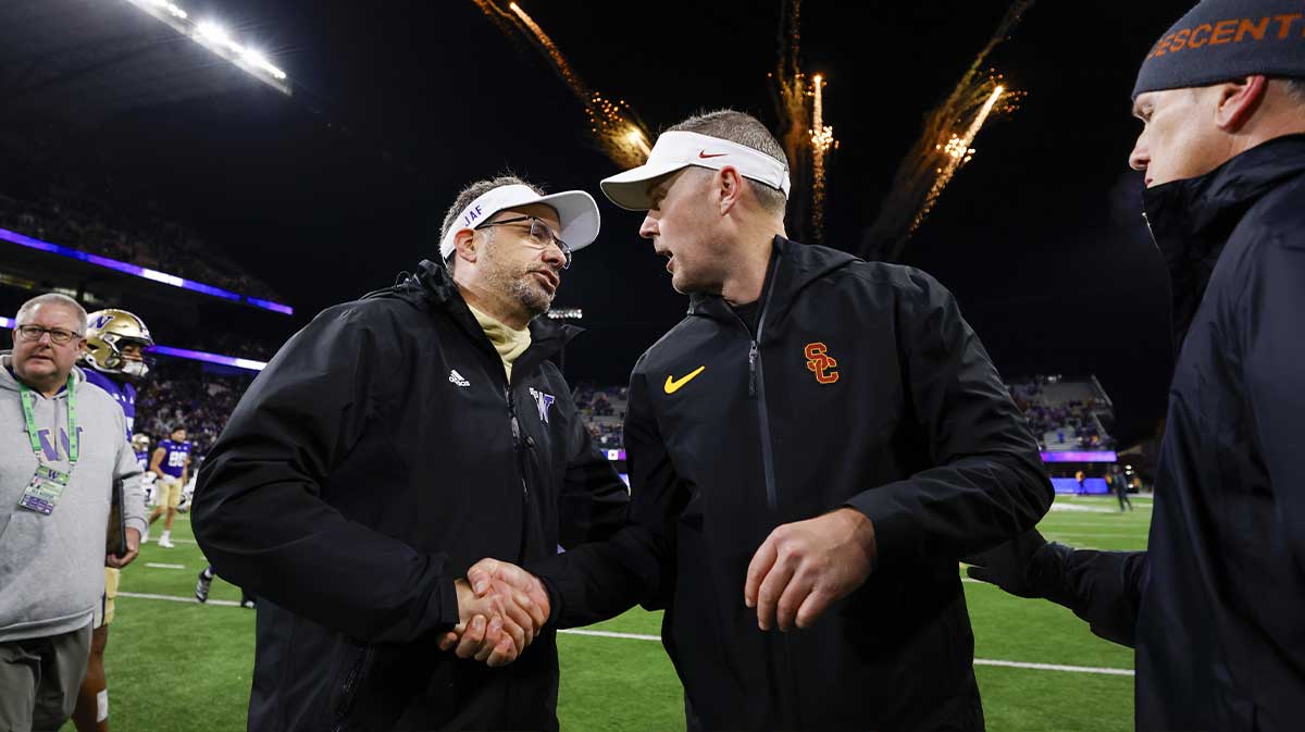 Washington Huskies head coach Jedd Fisch, left, shakes hands with USC Trojans head coach Lincoln Riley following a Washington victory at Alaska Airlines Field at Husky Stadium.