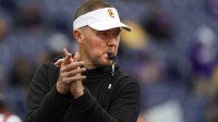 USC Trojans head coach Lincoln Riley watches pregame warmups against the Washington Huskies at Alaska Airlines Field at Husky Stadium.