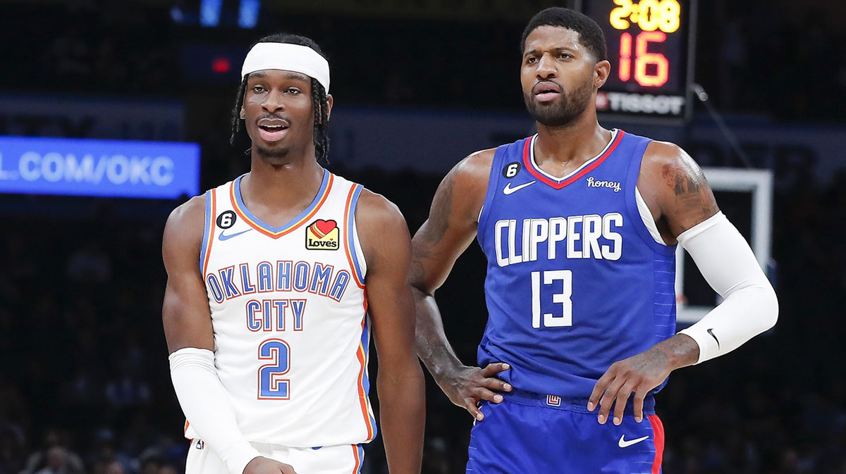 Oklahoma City Thunder guard Shai Gilgeous-Alexander (2) and LA Clippers guard Paul George (13) walks down the court during a time out during the first half at Paycom Center.