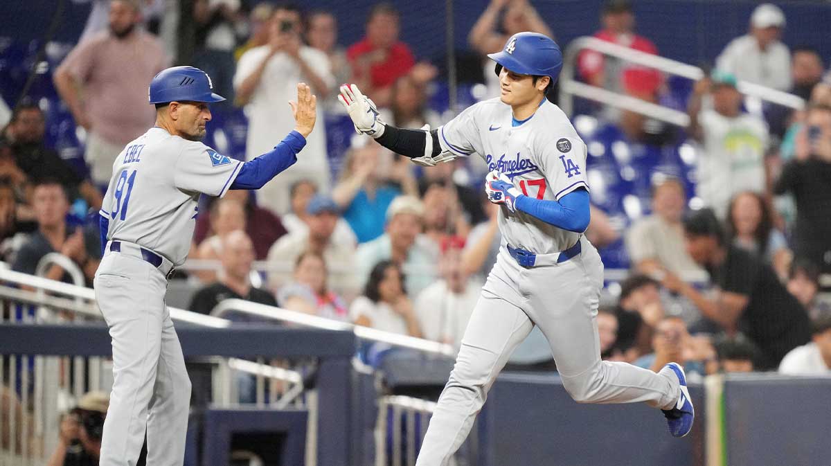 Los Angeles Dodgers designated hitter Shohei Ohtani (17) is congratulated by third base coach Dino Ebel (91) after hitting a home run against the Miami Marlins in the sixth inning at loanDepot Park.