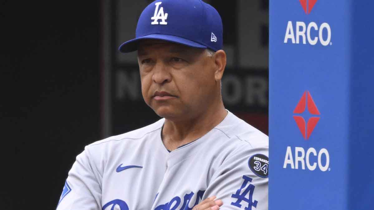 Los Angeles Dodgers manager Dave Roberts (30) stands in the dugout in the third inning against the Cleveland Guardians at Progressive Field.