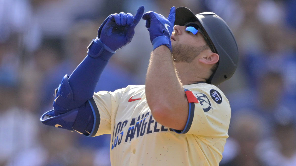 Los Angeles Dodgers third baseman Max Muncy (13) celebrates after hitting a three run home run against the New York Yankees in the second inning at Dodger Stadium.