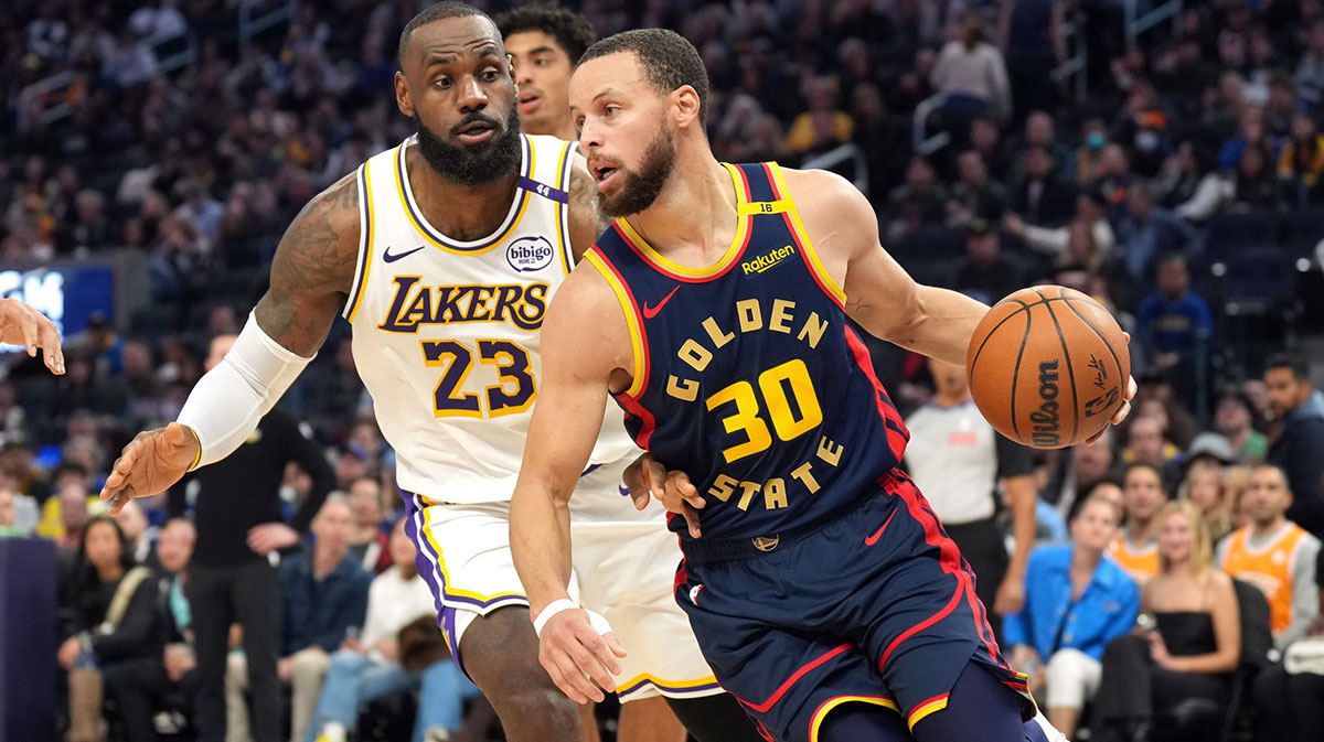 Golden State Warriors guard Stephen Curry (30) dribbles against Los Angeles Lakers forward LeBron James (23) during the third quarter at Chase Center.